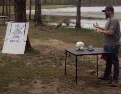 Students and presenter gathered at the soil health station at the Eco Day at the Piney Wood Rec Area